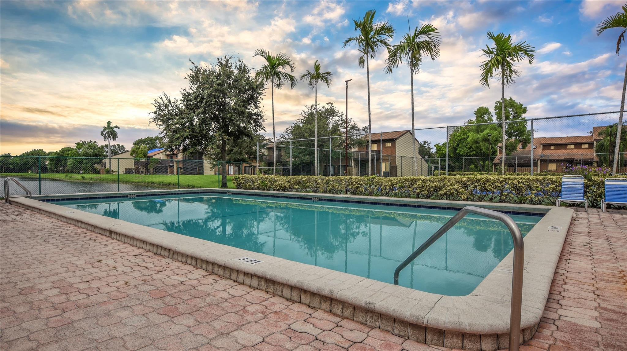 4285 South Pine Island Road, Unit 4285 Davie, FL 33328 - Photo 35 of 35 a view of a swimming pool with a yard and palm trees