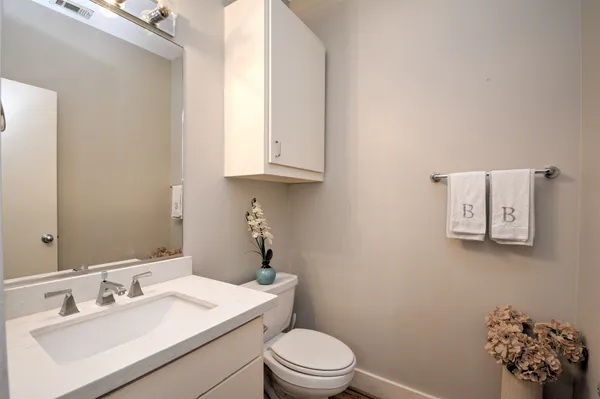 a bathroom with a sink a toilet and mirror