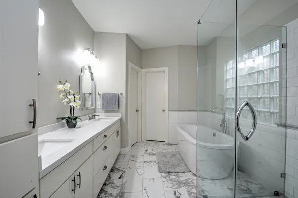 a bathroom with a granite countertop sink a toilet and bathtub