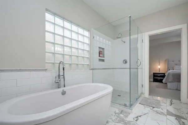 a bathroom with a bathtub and a shower