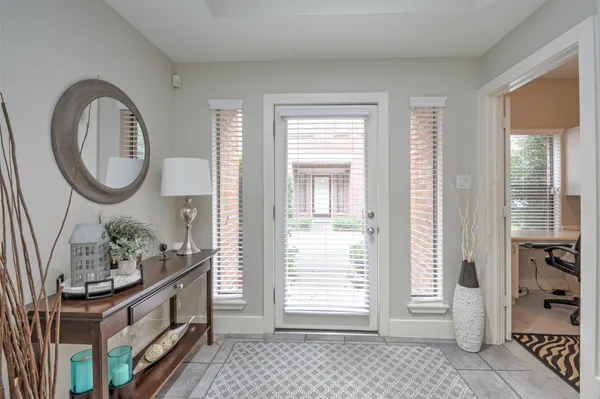 a spacious bathroom with a granite countertop sink and a mirror