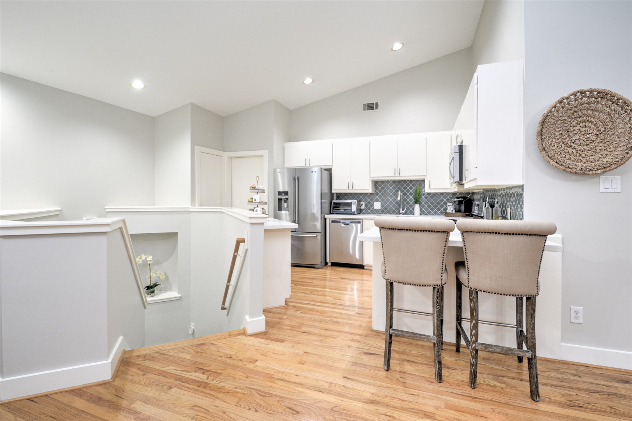 5225 Cornish Street, Unit 1 Houston, TX 77007 - Photo 7 of 22 a kitchen with stainless steel appliances a refrigerator a stove a sink dishwasher and white cabinets with wooden floor