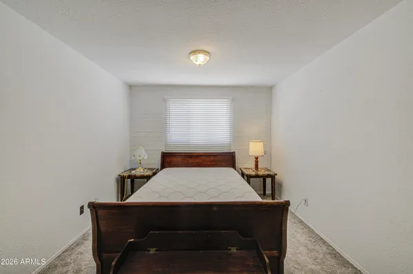 a bedroom with furniture and a window