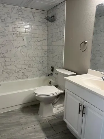 a bathroom with a toilet sink and shower