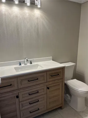 a bathroom with a sink toilet and vanity