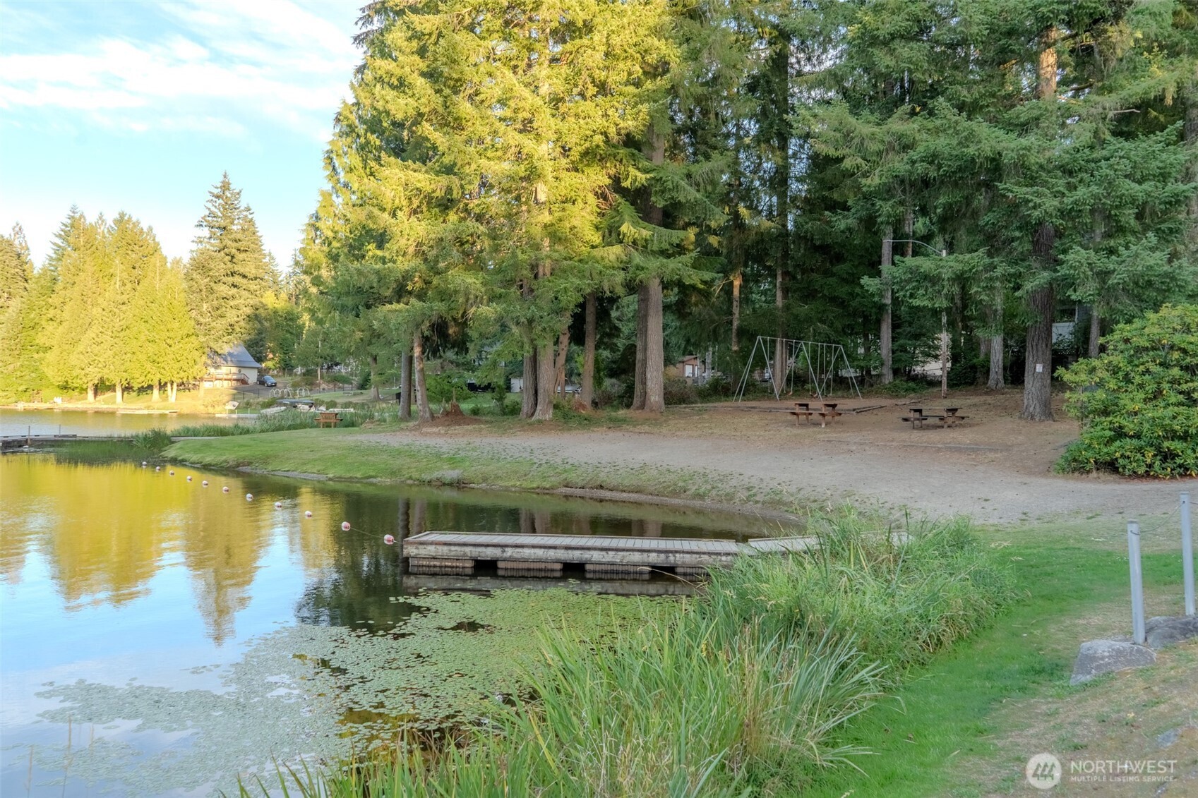 121 East Stavis Road Shelton, WA 98584 - Photo 20 of 35 a backyard of a house with lots of green space and lake view in back