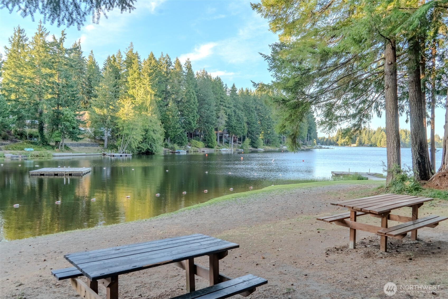 121 East Stavis Road Shelton, WA 98584 - Photo 23 of 35 a wooden bench sitting next to a lake