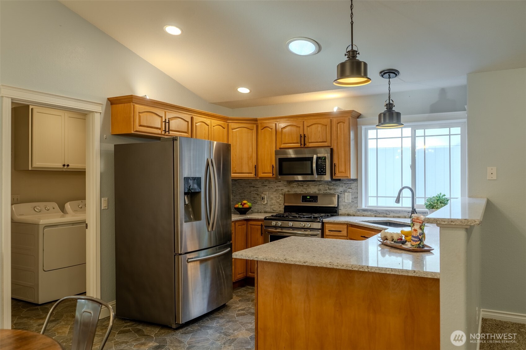 121 East Stavis Road Shelton, WA 98584 - Photo 3 of 35 a kitchen with stainless steel appliances granite countertop a refrigerator a stove and a sink with wooden floor