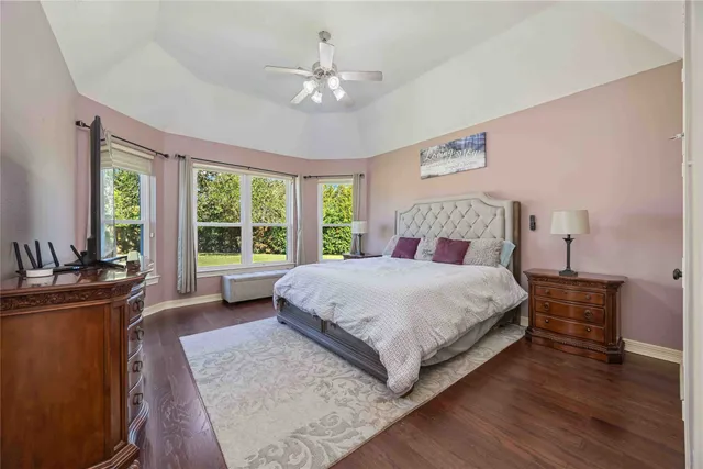 a bedroom with a large bed and a chandelier