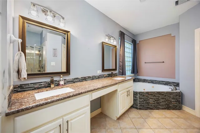 a bathroom with a double vanity sink and a mirror