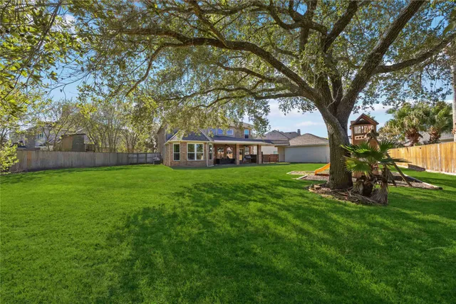 a view of a house with backyard and a slide