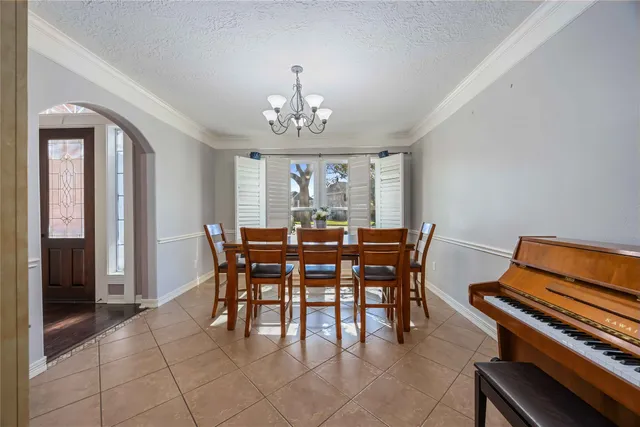a view of a dining room with furniture and chandelier