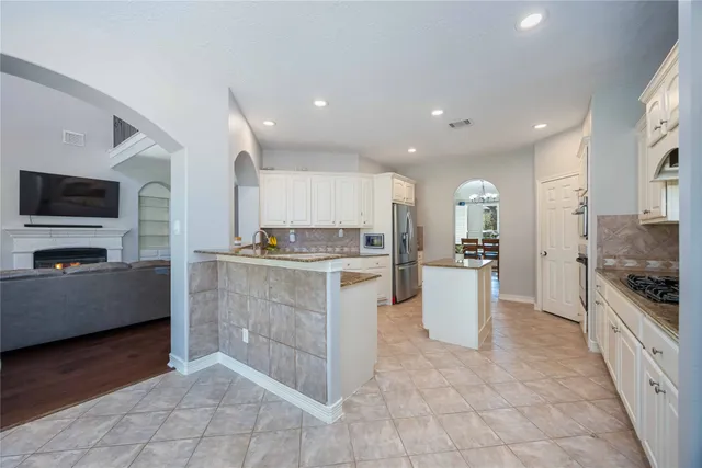 a kitchen with a sink and a stove top oven