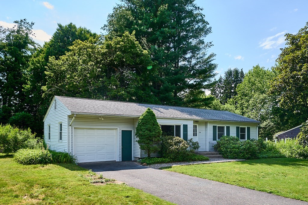 134 Tracy Circle Amherst, MA 01002 - Photo 1 of 37 a front view of a house with a yard and garage