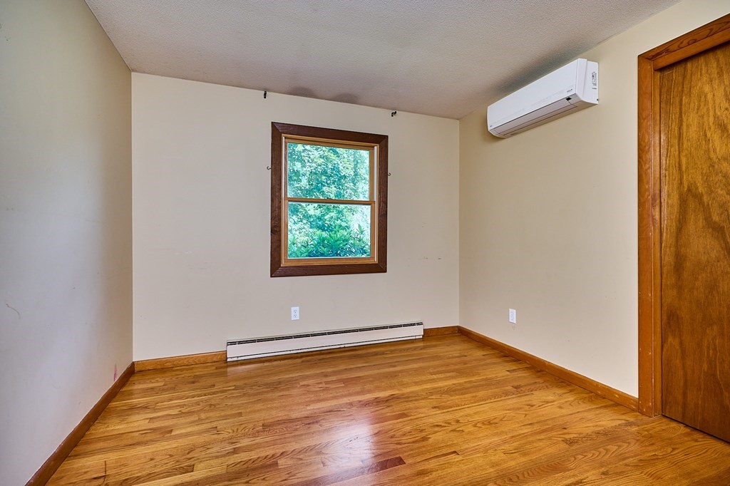 134 Tracy Circle Amherst, MA 01002 - Photo 12 of 37 an empty room with wooden floor and windows