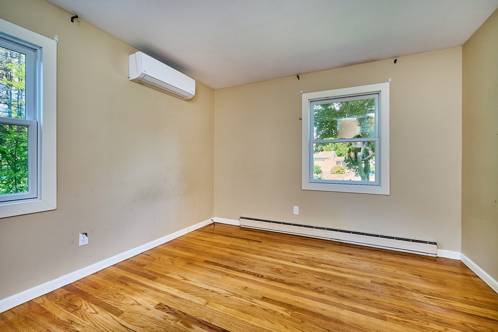134 Tracy Circle Amherst, MA 01002 - Photo 14 of 37 a view of an empty room with wooden floor and a window