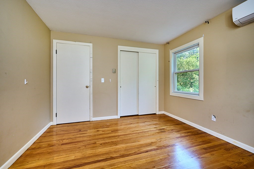 134 Tracy Circle Amherst, MA 01002 - Photo 15 of 37 a view of an empty room with wooden floor and a window