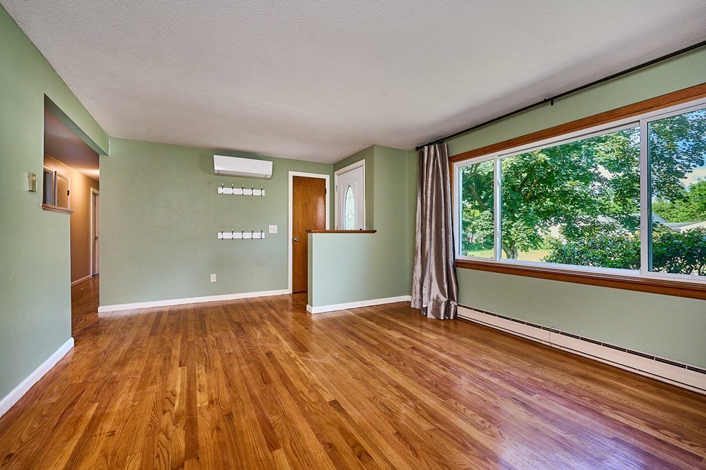 134 Tracy Circle Amherst, MA 01002 - Photo 3 of 37 a view of a big room with wooden floor and windows