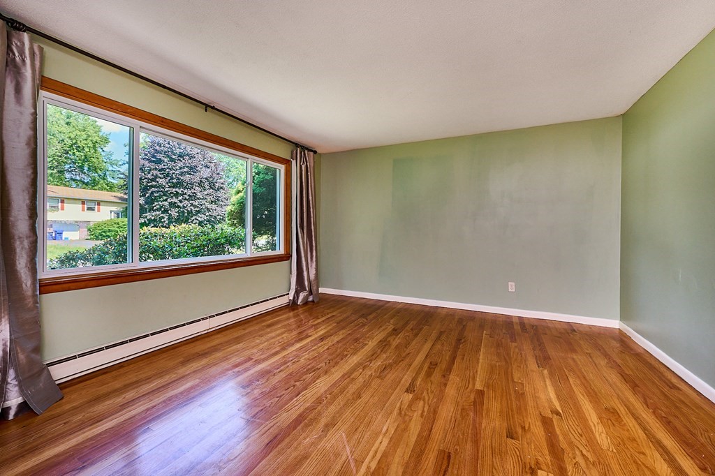 134 Tracy Circle Amherst, MA 01002 - Photo 4 of 37 a view of room with window and wooden floor