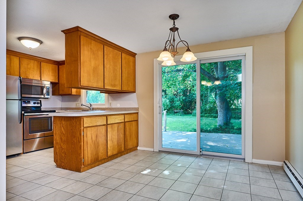 134 Tracy Circle Amherst, MA 01002 - Photo 5 of 37 a kitchen with stainless steel appliances granite countertop a stove a sink and a microwave