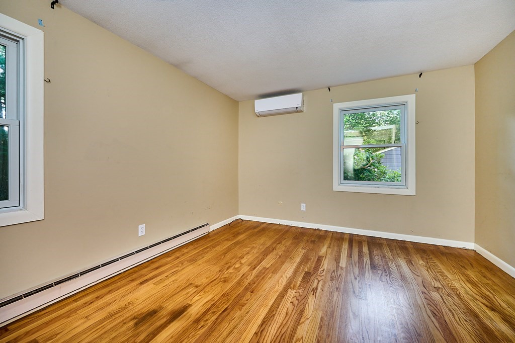 134 Tracy Circle Amherst, MA 01002 - Photo 9 of 37 a view of an empty room with wooden floor and a window