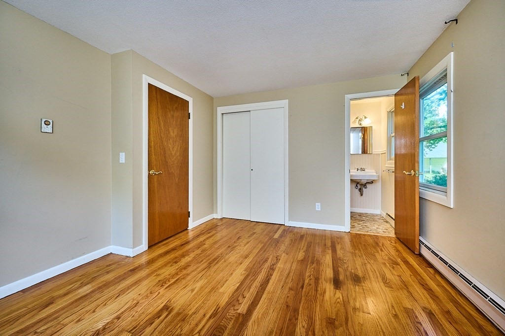 134 Tracy Circle Amherst, MA 01002 - Photo 10 of 37 a view of a room with wooden floor and brick walls