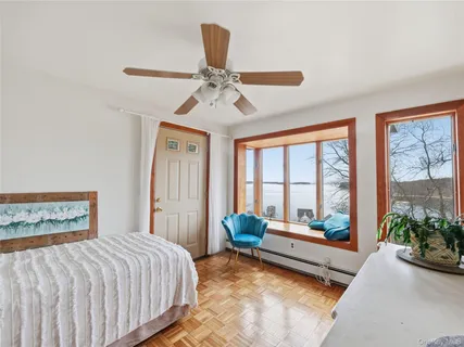 a spacious bedroom with a bed and a large window