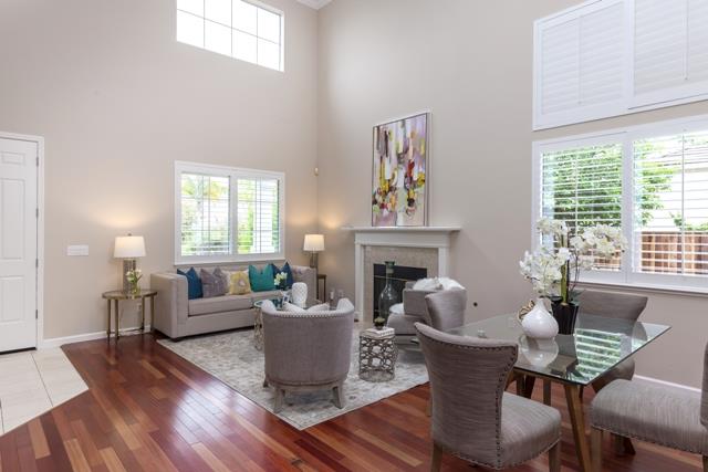 4597 Pacific Rim Way San Jose, CA 95121 - Photo 2 of 10 a living room with furniture two windows and a fireplace