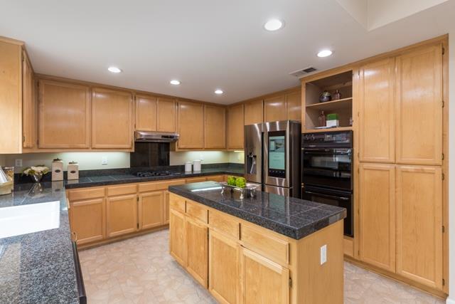 4597 Pacific Rim Way San Jose, CA 95121 - Photo 3 of 10 a kitchen with stainless steel appliances granite countertop a sink and a refrigerator