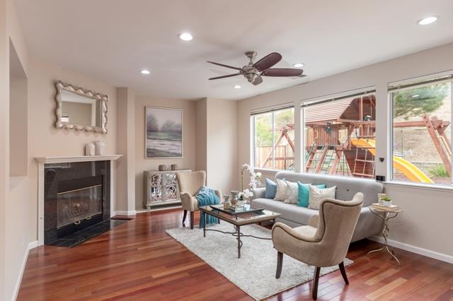 4597 Pacific Rim Way San Jose, CA 95121 - Photo 5 of 10 a living room with furniture a fireplace and a floor to ceiling window