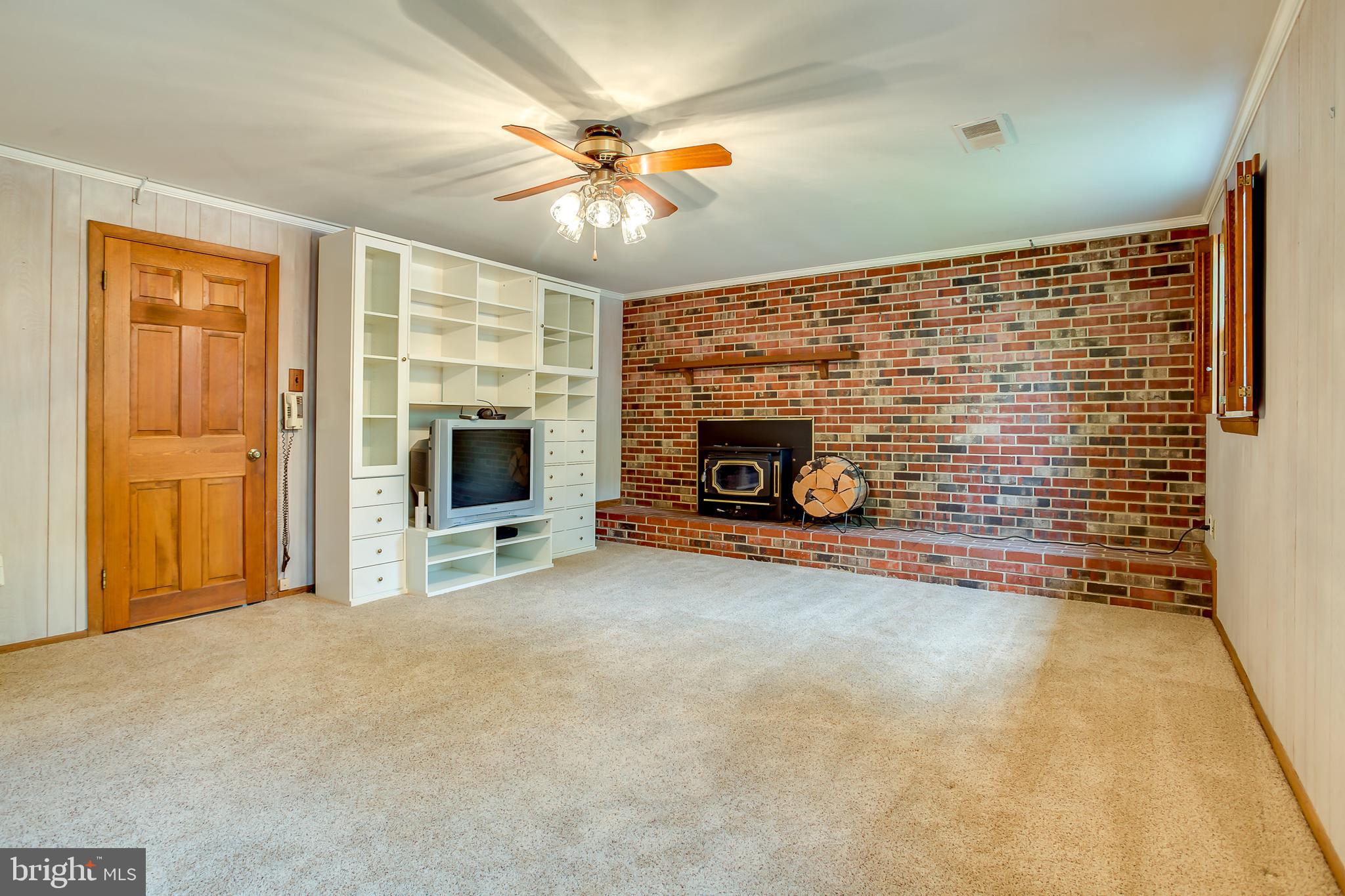 3143 Flintlock Road Fairfax, VA 22030 - Photo 23 of 48 Brick wall with wood burning stove