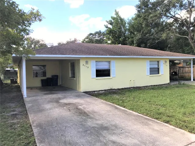 a view of a backyard with a garden and garage