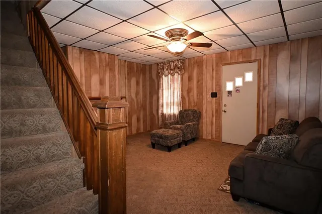 a living room with furniture and a chandelier
