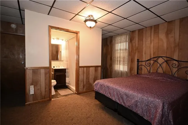 a bedroom with a bed and a mirror