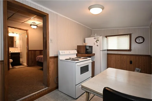 a kitchen with a stove a sink and a refrigerator