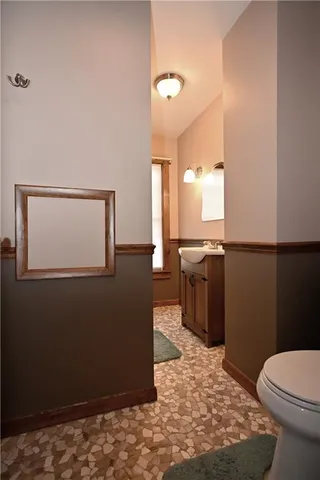 a bathroom with a sink a toilet and mirror