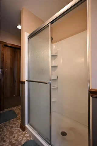 a bathroom with a glass shower door