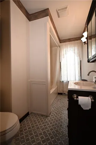 a bathroom with a sink a toilet and a shower