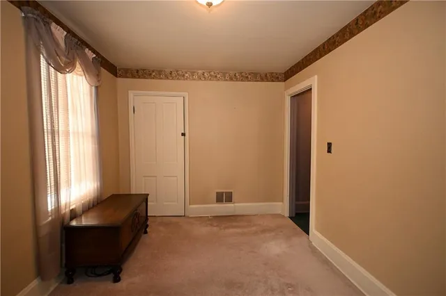a view of a livingroom with furniture and windows