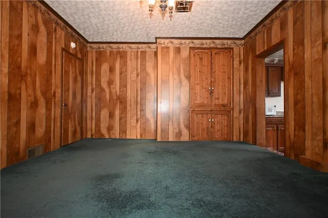 a view of a room with a wooden door