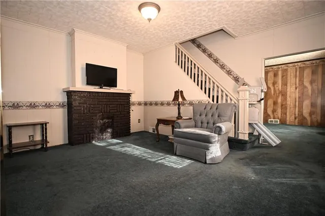 a living room with fireplace furniture and a flat screen tv