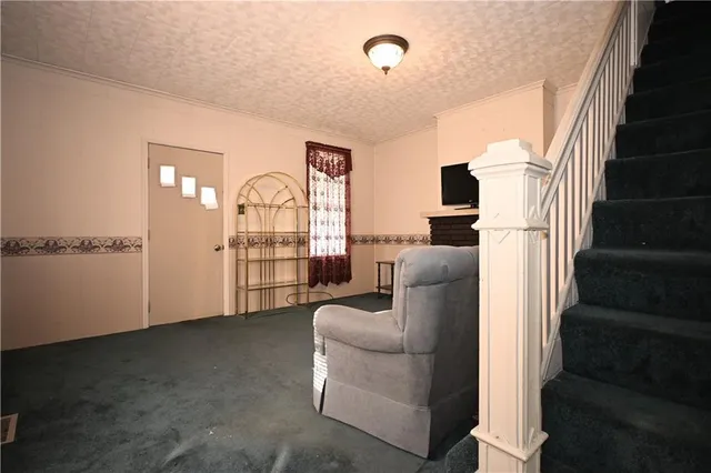 a living room with furniture or chandelier and a wooden floor