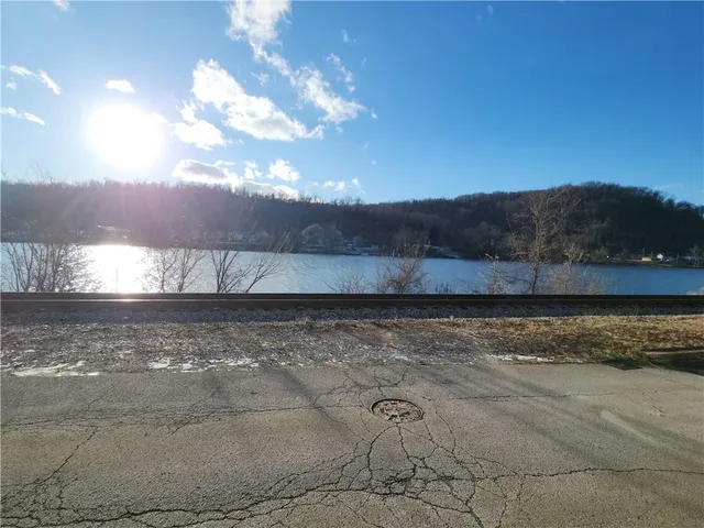 a view of a yard with wooden fence