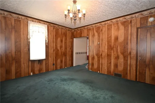 a view of a room with a window and a ceiling fan