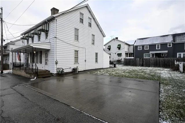 a view of a white house with a street