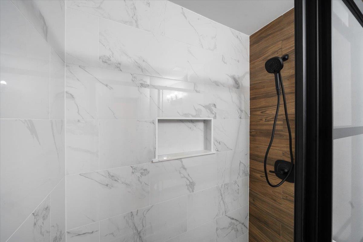 5399 Ross Road Memphis, TN 38141 - Photo 26 of 35 a bathroom with a glass shower door and mirror