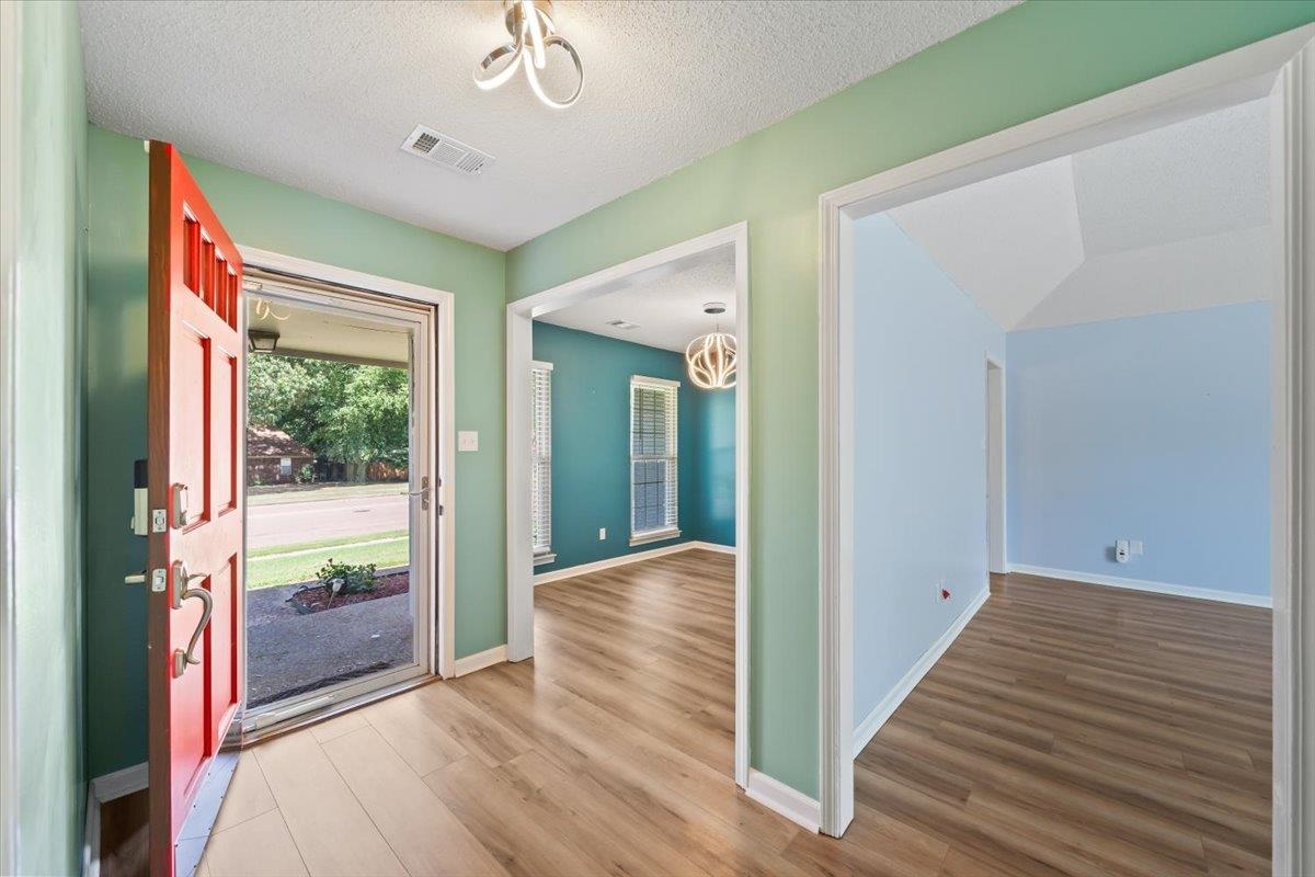 5399 Ross Road Memphis, TN 38141 - Photo 5 of 35 a view of a hallway with wooden floor and entryway