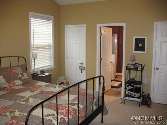 156 Pamlico Road Fletcher, NC 28732 - Photo 14 of 22 a bedroom with a bed a table and chair