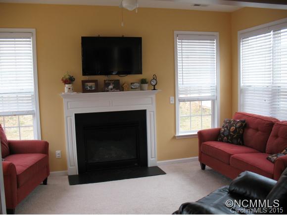 156 Pamlico Road Fletcher, NC 28732 - Photo 6 of 22 a living room with furniture a flat screen tv and a fireplace