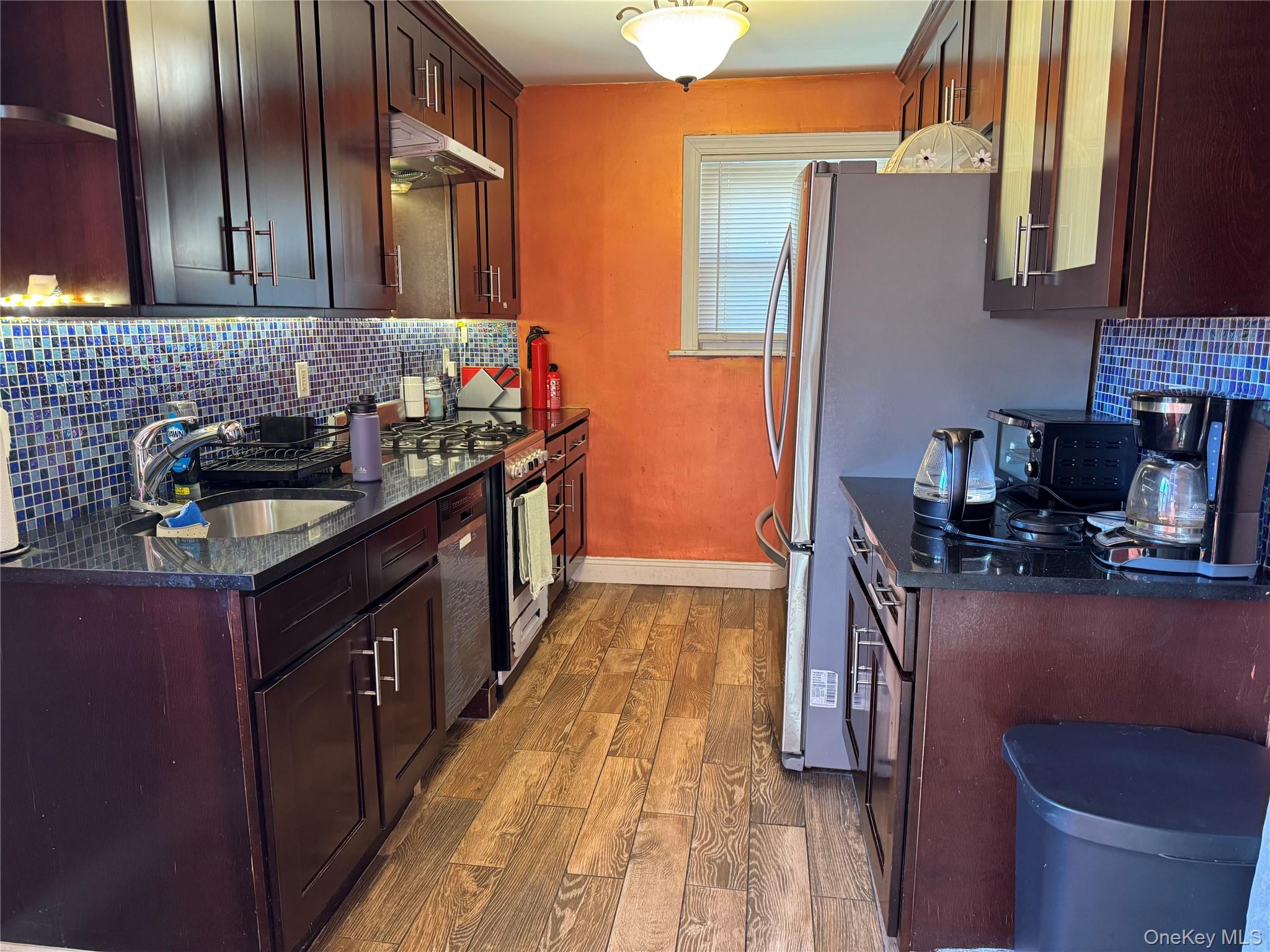 26 Parkside Drive Jericho, NY 11753 - Photo 12 of 25 a kitchen with granite countertop a sink stove and cabinets